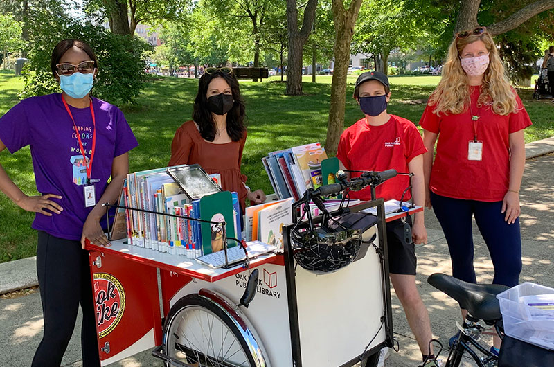 Community Engagement team members posing with the Book Bike