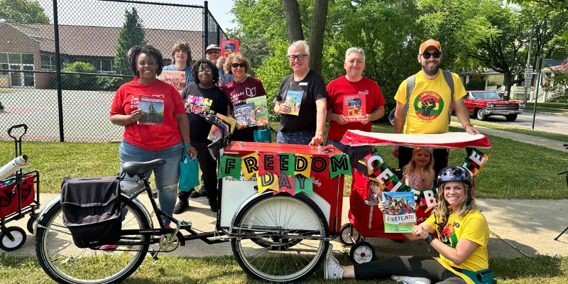 Library staff and board members posing with the Book Bike