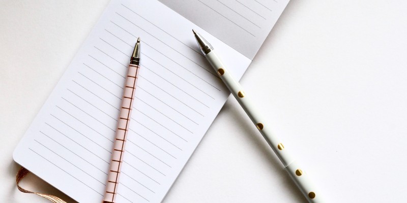 Open notebook with pens