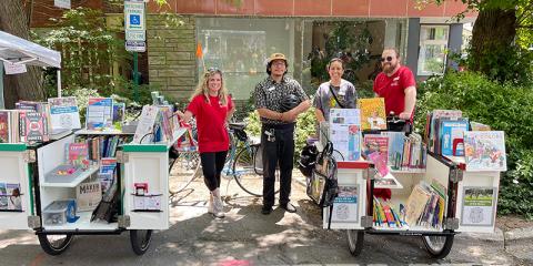 Library staff members posing with the Book Bikes