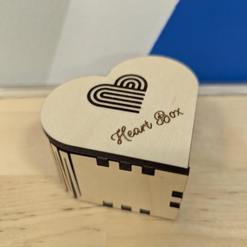 Photo of a heart-shaped box made of plywood that was cut and engraved using a laser cutter.