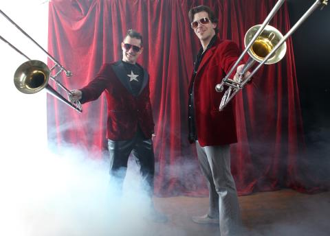 Horno Stars Band Photo. Two member of the band holding up horn instruments