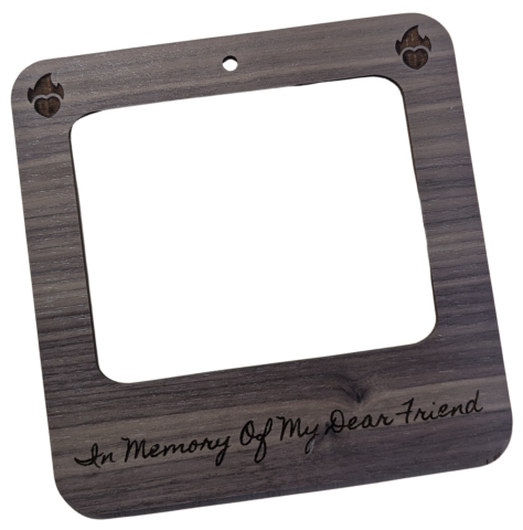 A photo frame made from walnut plywood with the engraved text "in memory of my dear friend" and engraved hearts with flames.